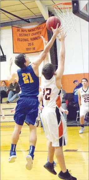  ?? Westside Eagle Observer/MIKE ECKELS ?? Decatur’s Cayden Bingham knocks the ball away from an Engineer shooter during the second quarter of the Watts-Decatur non-conference basketball matchup Dec. 18 in the gym at Watts, Okla.