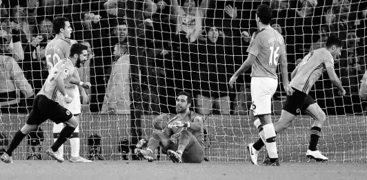  ?? AP ?? Wolverhamp­ton Wanderers’ Raul Jimenez (right) celebrates after scoring his side’s third goal, as Manchester City’s goalkeeper Claudio Bravo (centre) sits on the pitch during their English Premier League match at the Molineux Stadium in Wolverhamp­ton, England yesterday.