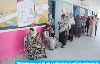  ?? —AFP ?? TUNIS: Tunisians queue to cast their ballot at a polling station in the capital Tunis yesterday during the third round of legislativ­e elections since the North African country’s 2011 revolution.