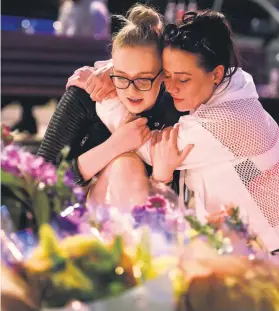  ?? Picture: Getty Images ?? TRIBUTE. A woman is consoled following an evening vigil outside the Town Hall in Manchester this week.