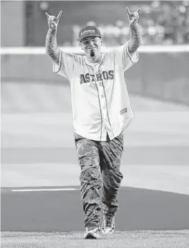  ?? Karen Warren / Houston Chronicle ?? Rapper Paul Wall reacts after throwing out the first pitch before the start of an MLB game at Minute Maid Park in 2016. “Baseball’s always been part of my life. I love all sports, but baseball’s my favorite,” the Houston native said.