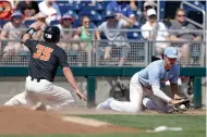  ?? AP Photo/Nati Harnik ?? ■ Oregon State's Adley Rutschman (35) slides safely to third base against North Carolina third baseman Kyle Datres, right, on a single by Kyle Nobach in the third inning of an NCAA College World Series baseball game Saturday in Omaha, Neb.