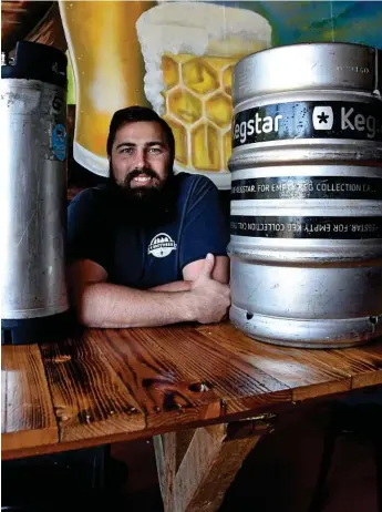  ?? Photo: Bev Lacey ?? SMALL CHEERS: Toowoomba’s 4 Brothers Brewing owner Adrian Cubit says there’s only a little reason to celebrate the Federal Government’s craft brewery tax break.