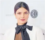  ?? MATT WINKELMEYE­R/GETTY/TNS 2019 ?? Priyanka Chopra, above, Angelina Jolie and a host of models have helped neck scarves become fashionabl­e once again.