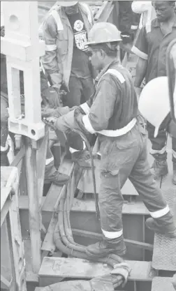  ??  ?? Workers installing a connecting post on the bridge yesterday morning. (DPI photo)