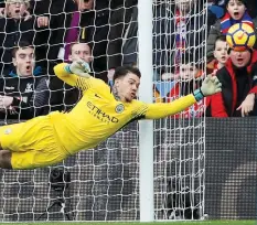  ?? (Reuters) ?? MANCHESTER CITY goalkeeper Ederson ensured his team remained unbeaten in Premier League action this season with a stoppage-time penalty save in yesterday’s 0-0 draw against Crystal Palace.