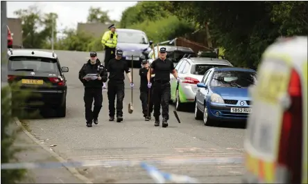  ??  ?? Police officers at the scene of the attack on Mr McGettigan in Auchinairn last July