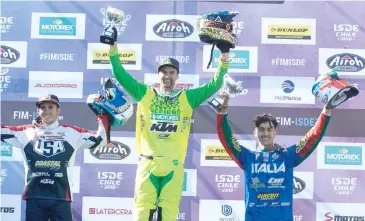  ??  ?? Daniel Milner takes the top step on the podium after taking out the E3 world champion title in Chile.