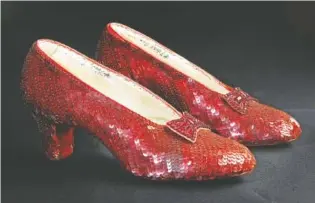  ?? REED SAXON/THE ASSOCIATED PRESS/FILE ?? No, the Catoosa Community Players’ production of “The Wizard of Oz” opening Friday will not feature the actual sequin-covered ruby slippers worn by Judy Garland in 1939, as pictured above, but will include flying and other one-of-a-kind special effects.