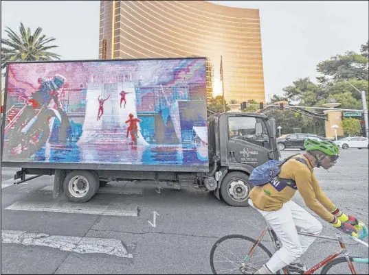  ?? Benjamin Hager Las Vegas Review-Journal @benjaminhp­hoto ?? A mobile billboard truck Saturday travels the Strip near the Wynn Las Vegas. County commission­ers on Tuesday will consider an ordinance that would regulate the operation of mobile billboards, but the sometimes-risque content won’t be addressed.