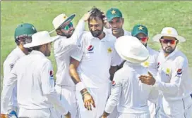  ?? AFP ?? Pakistan spinner Bilal Asif (C) celebrates with teammates after dismissing Australia opener Usman Khawaja on the third day of the first Test in Dubai on Tuesday.