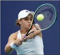  ?? LYNNE SLADKY — THE ASSOCIATED PRESS ?? Ash Barty returns a shot to Bianca Andreescu during the finals at the Miami Open on Saturday. Barty won 6-3, 4-0, as Andreescu retired due to injury.