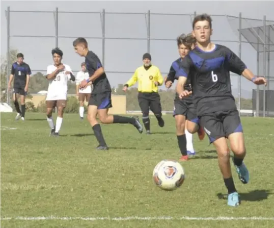  ?? Photo by Ger Demarest. ?? East Mountain's Kyle Hofmann chasing down a through ball during the T'wolves' matchup against the OGMEC Owls, Oct. 12, 2021.