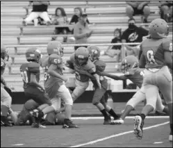  ?? Photo by Alexis Meeks ?? A Malvern 5th grader fights for yards against the Glen Rose 5th grade defense.