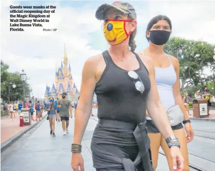  ?? Photo / AP ?? Guests wear masks at the official reopening day of the Magic Kingdom at Walt Disney World in Lake Buena Vista, Florida.