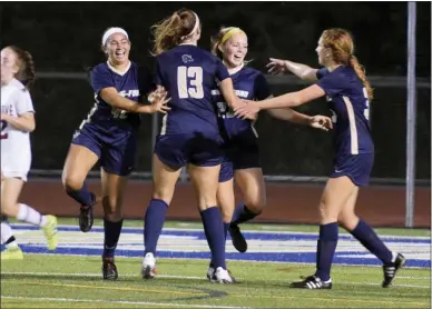  ?? AUSTIN HERTZOG - MEDIANEWS GROUP ?? Spring-Ford’s Emily Higgins, second from right, is congratula­ted after scoring the go-ahead goal against Pottsgrove Tuesday.