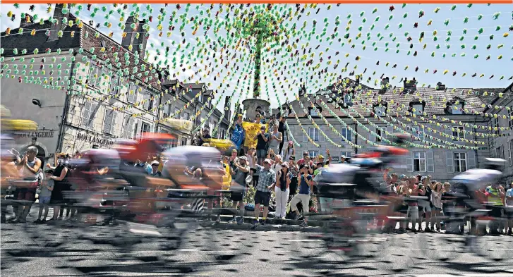  ??  ?? Speed freaks: Spectators greet the peloton during yesterday’s stage from Dole to Station des Rousses, which was won by the Frenchman Lilian Calmejane on his Tour debut, and ended with Chris Froome still in yellow