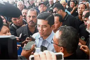  ??  ?? State matters: Azmin (centre) speaking to the media after opening the Pahlawan convention in Shah Alam.