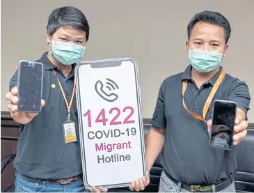  ?? PHOTO BY THE WORLD HEALTH ORGANIZATI­ON THAILAND ?? Maw la Myine, right, with his colleague Zaw Zaw Latt at the launch of the migrant hotline for Covid-19 in Khmer, Lao and Burmese languages.