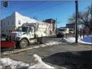  ??  ?? Several plows could be seen driving down Columbia Street in Cohoes Wednesday morning as part of the city’s snow removal process.