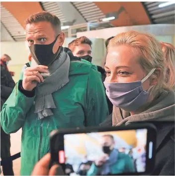  ?? FOTO: MSTYSLAV CHERNOV/AP/DPA ?? Alexej Nawalny und seine Frau Julia stehen am Flughafen Scheremetj­ewo.