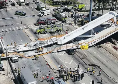  ?? DRONEBASE VIA AP ?? Emergency crews work at the scene of the collapsed 950-ton pedestrian bridge at Florida Internatio­nal University in the Miami area on Thursday.