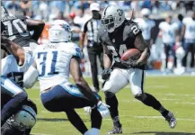 ?? Mark Zaleski ?? Marshawn Lynch (24) ran 18 times for 76 yards Sunday in a seasonopen­ing victory over the Tennessee Titans.
The Associated Press