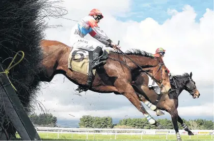  ?? PHOTO: PETER RUBERY ?? Watch your back . . . Gagarin and Shaun Fannin lead Des De Jeu and Aaron Kuru in the latter pair’s remarkable steeplecha­se at Awapuni on Saturday.