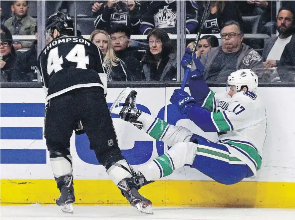  ?? — THE ASSOCIATED PRESS ?? Los Angeles Kings centre Nate Thompson and Vancouver Canucks centre Nic Dowd tangle in the first period on Monday in Los Angeles. While the Canucks kept the Kings off the board in the first, the goals did come — and Vancouver got none in a 3-0 loss.