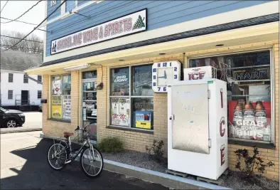  ?? Arnold Gold / Hearst Connecticu­t Media ?? Shoreline Wine & Spirits on Main Street in Branford was closed Wednesday as owner Ashwin Patel recovered from a bullet wound after a shooter fired from a second-floor apartment nearby at 241 Main St. the previous day.