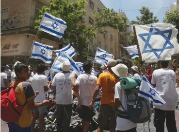  ?? (Marc Israel Sellem/The Jerusalem Post) ?? TEENS CELEBRATE Jerusalem Day in downtown Jerusalem. Thinking of Israel as a mythical state is not in line with reality, and stems from a romantic view of what Israel and the Jewish people are.