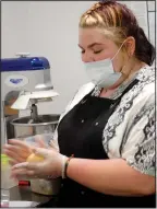  ??  ?? Employee Claudia Riley rolls a ball of empanada dough.