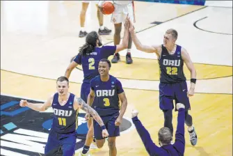  ?? Robert Franklin The Associated Press ?? Oral Roberts players celebrate after beating Ohio State Friday in the first round of the NCAA Tournament.