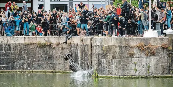  ?? FOTO REUTERS ?? Už se koupe! V Bristolu aktivisté strhli a shodili do řeky pomník známého obchodníka ze 17. století Edwarda Colstona, jenž se mimo jiné věnoval dovozu otroků.