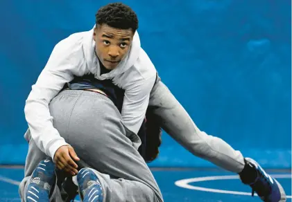  ?? CLOE POISSON/SPECIAL TO THE COURANT ?? Isaiah Adams, top, a senior on the Avon High School wrestling team, wrestles Reese Titus, a Canton High School junior, in a three-school practice Wednesday at Avon High School. Adams is unbeaten this season with a 46-0 record.