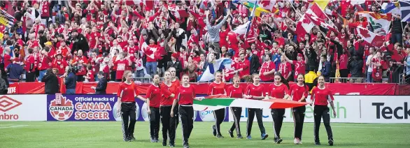  ?? THE CANADIAN PRESS/DARRYL DYCK ?? Flags are carried onto the field before a FIFA World Cup qualifying match in Vancouver in 2016. The city hopes to host games in the 2026 FIFA World Cup.