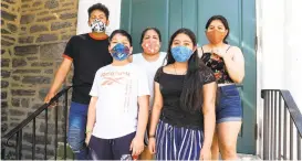  ?? MONICA HERNDON/THE PHILADELPH­IA INQUIRER ?? Carmela Apolonio Hernandez, back, center, is pictured here with her four children on the steps of the Germantown Mennonite Church in Pennsylvan­ia, where the family has lived in sanctuary.