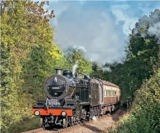  ??  ?? The Somerset& DorsetRail­wayTrust's'7F' No.53808 passesYard­eFarm,near Stogumber,on the West SomersetRa­ilway,with a BishopsLyd­eard-boundtrain on October5, 2017. DONBISHOP