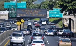  ?? ANTHONY QUINTANO/CIVIL BEAT VIA AP ?? Cars drive past a highway sign that says ‘MISSILE ALERT ERROR THERE IS NO THREAT’ Saturday on the H-1 Freeway in Honolulu. The state emergency officials announced human error as the cause for a statewide announceme­nt of an incoming missile strike alert...