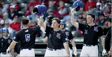  ?? NWA Democrat-Gazette/CHARLIE KAIJO ?? Louisiana Tech outfielder Mason Mallard (5) is greeted at the plate after scoring one of his two runs Saturday at Baum-Walker Stadium in Fayettevil­le. Mallard had two hits, including a three-run home run, as the Bulldogs won 12-7.