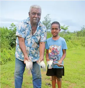  ?? Photo: Ministry of Fisheries ?? Manasa Nasilivata and his grandson and namesake Manasa Nasilivata with the tilapia harvested from their farm.