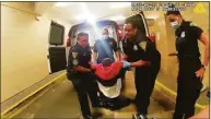  ?? Associated Press ?? In this image taken from police body camera video provided by New Haven Police, Richard "Randy" Cox, center, is pulled from the back of a police van and placed in a wheelchair after being detained by New Haven Police on June 19 in New Haven.