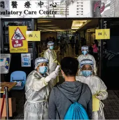  ?? BILLY H.C. KWOK/THE NEW YORK TIMES ?? Medical workers check Tuesday for coronaviru­s at a hospital in Hong Kong, where thousands called for closing the border.