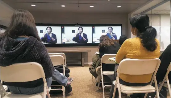  ?? Courtney Linder/Post-Gazette ?? Attendees from BNY Mellon and Ellevate’s Pittsburgh network sit in on a webinar panel and live conversati­on about empowering women in tech on Monday.