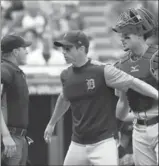  ?? RON SCHWANE, THE ASSOCIATED PRESS ?? Detroit Tigers manager Brad Ausmus and catcher James McCann argue with home plate umpire Quinn Wolcott during the third inning of Wednesday’s game.