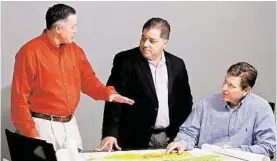  ??  ?? Newfield Exploratio­n Co.’s John Jasek, left, Lee K. Boothby and Steve Campbell confer.