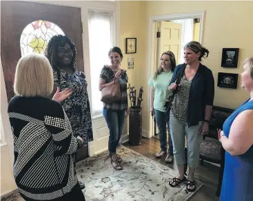  ??  ?? Rhonda Kelley, left, hosts female students for tea in the president’s home on the campus of New Orleans Baptist Theologica­l Seminary. “Our biblically assigned role is to submit to men,” she believes.