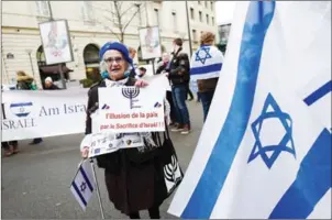  ?? PIERRE CONSTANT/AFP ?? A woman holds a sign reading ‘The illusion of peace by the sacrifice of Israel’ during a protest in Paris yesterday against the Paris Middle East peace conference.