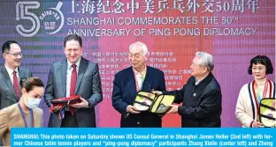  ??  ?? SHANGHAI: This photo taken on Saturday shows US Consul General in Shanghai James Heller (2nd left) with former Chinese table tennis players and “ping-pong diplomacy” participan­ts Zhang Xielin (center left) and Zheng Minzhi (far right) receiving souvenirs during a ceremony to mark the 50th anniversar­y of the diplomatic event at the Internatio­nal Table Tennis Federation museum in Shanghai. — AFP