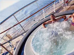  ??  ?? Relax: Enjoying the bubbles on Cruise & Maritime’s Magellan